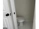 Enclosed toilet area features white toilet and white tile flooring at 1126 Old Jackson Rd, Locust Grove, GA 30248
