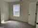Cozy bedroom with a large window offering natural light and a neutral color palette at 1126 Old Jackson Rd, Locust Grove, GA 30248
