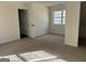 Neutral carpeted bedroom has natural light from window and plenty of outlets for convenience at 1126 Old Jackson Rd, Locust Grove, GA 30248