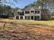Charming two-story home with black shutters, white paint, black roof and a well-manicured lawn at 1126 Old Jackson Rd, Locust Grove, GA 30248