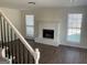 Bright living room with a charming white brick fireplace and two windows offering natural light at 1126 Old Jackson Rd, Locust Grove, GA 30248