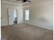 Carpeted main bedroom with a ceiling fan, a window and an ensuite bathroom at 1126 Old Jackson Rd, Locust Grove, GA 30248