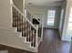 View of a carpeted staircase with white risers and black metal balusters, leading to the upper level at 1126 Old Jackson Rd, Locust Grove, GA 30248