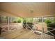 Cozy screened-in back porch with wood floors offers a relaxing outdoor space at 35 East Honeysuckle Ln, Carrollton, GA 30116