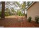 Backyard with fence, landscaping, and mature trees at 35 East Honeysuckle Ln, Carrollton, GA 30116