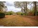 Large, level backyard with mature trees provides plenty of shade at 35 East Honeysuckle Ln, Carrollton, GA 30116
