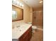 Bathroom featuring a window, large framed mirror, and a shower with curtain at 35 East Honeysuckle Ln, Carrollton, GA 30116