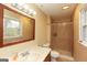 Bathroom featuring a window, large framed mirror, and a shower with curtain at 35 East Honeysuckle Ln, Carrollton, GA 30116