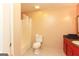 Comfortable bathroom featuring a tub shower, red cabinets, and white tile flooring at 35 East Honeysuckle Ln, Carrollton, GA 30116