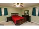 Comfortable bedroom with neutral carpet, ceiling fan and black wood bedroom set at 35 East Honeysuckle Ln, Carrollton, GA 30116
