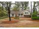 A well-maintained lawn, mature trees and beautiful landscaping surrounds this traditional style home at 35 East Honeysuckle Ln, Carrollton, GA 30116
