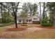 A well-maintained lawn, mature trees and beautiful landscaping surrounds this traditional style home at 35 East Honeysuckle Ln, Carrollton, GA 30116
