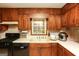 Kitchen features dark wood cabinets, white countertops and stainless steel appliances at 35 East Honeysuckle Ln, Carrollton, GA 30116