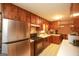 Kitchen featuring a large stainless steel refrigerator and vintage wood cabinets at 35 East Honeysuckle Ln, Carrollton, GA 30116