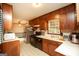 Vintage kitchen with dark cabinetry, stainless appliances, and patterned flooring at 35 East Honeysuckle Ln, Carrollton, GA 30116