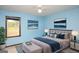 Comfortable bedroom featuring cool color paint, modern lighting, and scenic wall art at 35 East Honeysuckle Ln, Carrollton, GA 30116