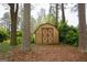 Outdoor shed in backyard surrounded by mature trees at 35 East Honeysuckle Ln, Carrollton, GA 30116