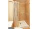 Tile shower featuring a shower curtain with tan and white tiles and a built-in seat at 35 East Honeysuckle Ln, Carrollton, GA 30116