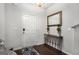 Inviting entryway with dark wood floors, elegant mirror, and stylish decor at 1310 Rogers Trce, Lithonia, GA 30058