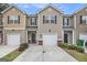 Charming townhouse with tan siding, brick accents, and well-maintained landscaping at 1310 Rogers Trce, Lithonia, GA 30058