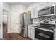 Well-equipped kitchen featuring stainless steel appliances and white cabinets at 1310 Rogers Trce, Lithonia, GA 30058