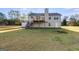 A large, grassy backyard with a deck and staircase for outdoor enjoyment at 217 Old Carrollton Rd, Carrollton, GA 30116