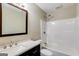 Bright bathroom featuring a shower-tub combo with dark wood cabinets at 217 Old Carrollton Rd, Carrollton, GA 30116
