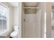 Bright bathroom with a stall shower, toilet, and a window for natural light at 217 Old Carrollton Rd, Carrollton, GA 30116