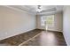 Spacious bedroom showcasing tray ceilings, hardwood floors, and natural light from a large window at 217 Old Carrollton Rd, Carrollton, GA 30116