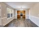 Dining room featuring hardwood floors, a window, and an adjacent kitchen at 217 Old Carrollton Rd, Carrollton, GA 30116