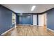 Spacious living room with wood-look floors and a neutral color palette at 217 Old Carrollton Rd, Carrollton, GA 30116