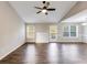 Bright living room featuring hardwood floors, a ceiling fan, and a fireplace at 217 Old Carrollton Rd, Carrollton, GA 30116