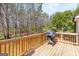 Wooden back deck perfect for grilling, with a lovely view of the surrounding trees at 275 Cedars Glen Cir, Villa Rica, GA 30180