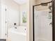 Bright bathroom with a tub, window, shower with black trim, and neutral tile accents at 275 Cedars Glen Cir, Villa Rica, GA 30180