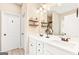 Bright bathroom with double sinks, vanity, decorative shelves, white cabinets and bronze fixtures at 275 Cedars Glen Cir, Villa Rica, GA 30180