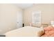 Comfortable bedroom with window, crib, soft yellow paint, and plush carpet at 275 Cedars Glen Cir, Villa Rica, GA 30180