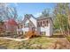 Side view of a white two-story home with a lawn and wooden staircase leading to the front door at 275 Cedars Glen Cir, Villa Rica, GA 30180