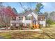 Charming two-story home with white siding, wood shutters, stone accents, and a well-manicured lawn at 275 Cedars Glen Cir, Villa Rica, GA 30180