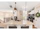 Well-lit kitchen showcases granite countertops, breakfast bar, stainless appliances, and staircase at 275 Cedars Glen Cir, Villa Rica, GA 30180