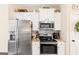 Bright kitchen features stainless steel appliances, granite countertops, and white cabinets at 275 Cedars Glen Cir, Villa Rica, GA 30180