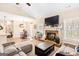 Inviting living room featuring a cozy fireplace, large screen TV, and comfortable seating at 275 Cedars Glen Cir, Villa Rica, GA 30180