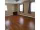 Large bedroom offers multiple windows and classic hardwood flooring throughout at 2563 Highway 81 E, Mcdonough, GA 30252