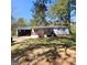Charming single-story home with a welcoming front porch and convenient carport, surrounded by mature trees and a spacious yard at 2563 Highway 81 E, Mcdonough, GA 30252