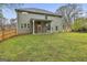 View of the lush backyard with a covered patio and bicycle rack, perfect for outdoor entertaining at 205 Valley View Dr, Tyrone, GA 30290