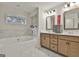 Bright bathroom with double vanity and soaking tub with tiled backsplash at 205 Valley View Dr, Tyrone, GA 30290