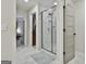 Bathroom with large walk-in shower featuring glass door, tile surround, and blue rug at 205 Valley View Dr, Tyrone, GA 30290