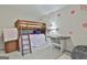 Bedroom featuring bunk beds, desk, bean bag, and flower wall decor at 205 Valley View Dr, Tyrone, GA 30290