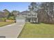 Charming two-story home with a well-maintained lawn, long driveway and attached two-car garage at 205 Valley View Dr, Tyrone, GA 30290