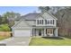 Charming two-story home with a well-maintained lawn and attached two-car garage at 205 Valley View Dr, Tyrone, GA 30290