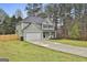 Charming two-story home with a well-maintained lawn, long driveway and attached two-car garage at 205 Valley View Dr, Tyrone, GA 30290